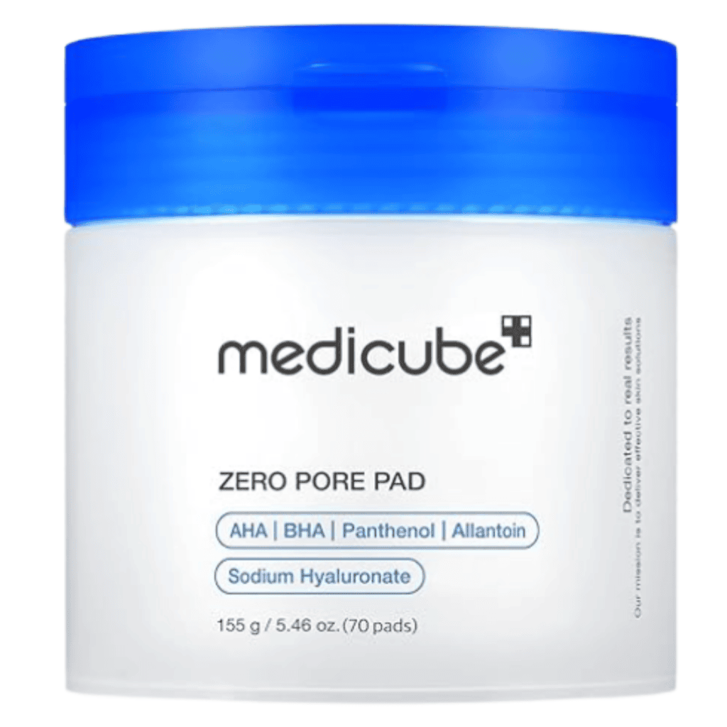 A white jar with a blue lid labeled “medicube ZERO PORE PAD,” one of our best selling products, featuring ingredients like AHA, BHA, Panthenol, Allantoin, and Sodium Hyaluronate, and a net weight of 155g (70 pads).