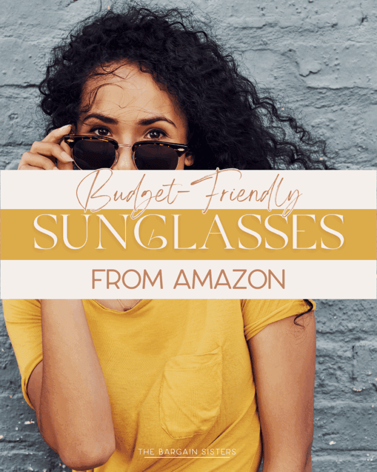 Woman in a yellow shirt holding sunglasses up to her face, standing against a textured gray wall. Text overlay reads: "Budget-Friendly Sunglasses from Amazon. The Bargain Sisters.