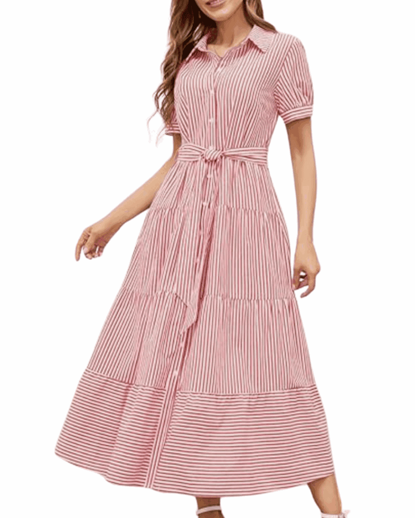 A woman wearing a pink and white vertically striped, button-down maxi dress with short sleeves, a collar, and a waist tie.