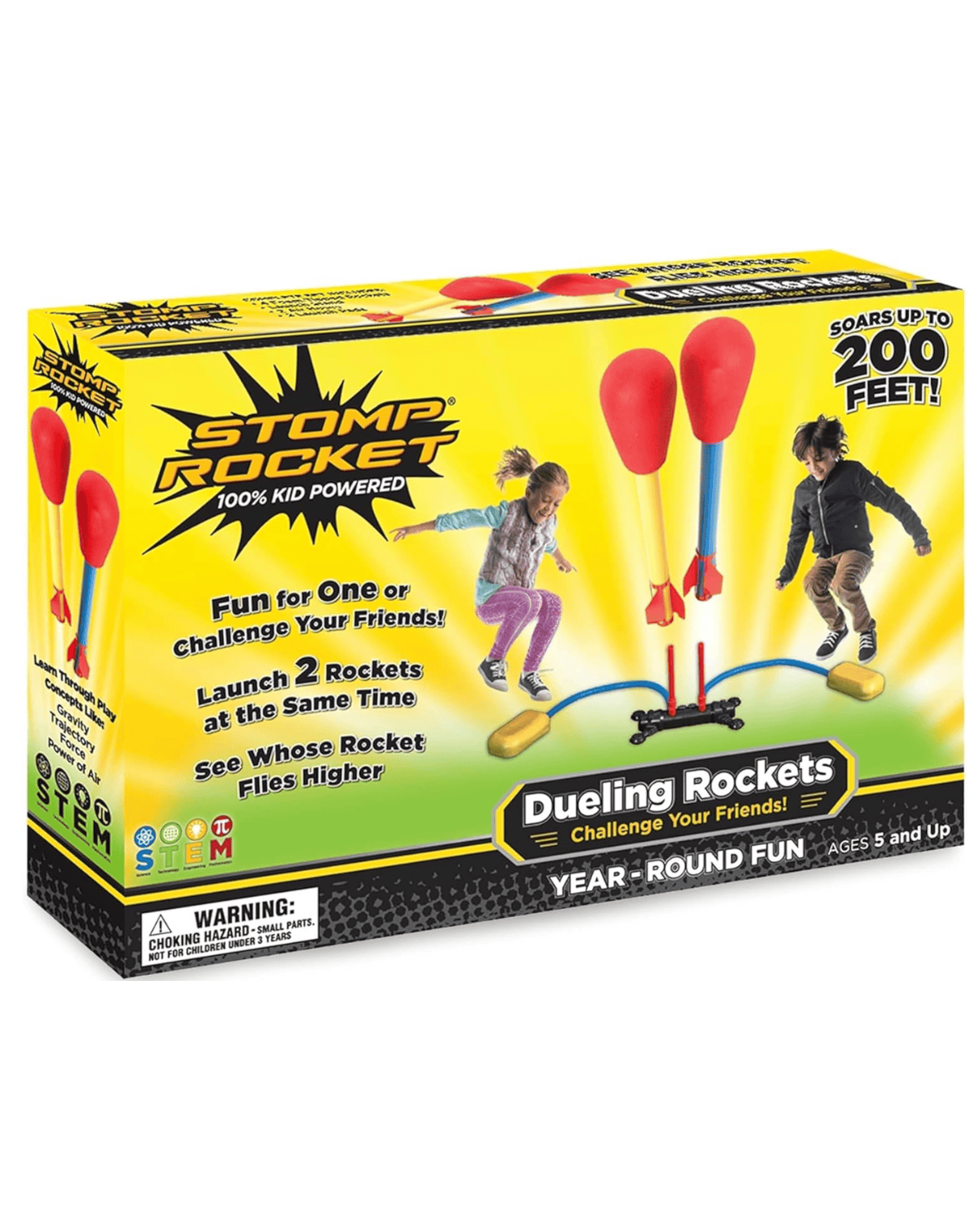 A box for "Stomp Rocket Dueling Rockets" toy shows two kids jumping on launch pads, sending two foam rockets into the air. The packaging highlights launching rockets up to 200 feet and is for ages 5 and up.