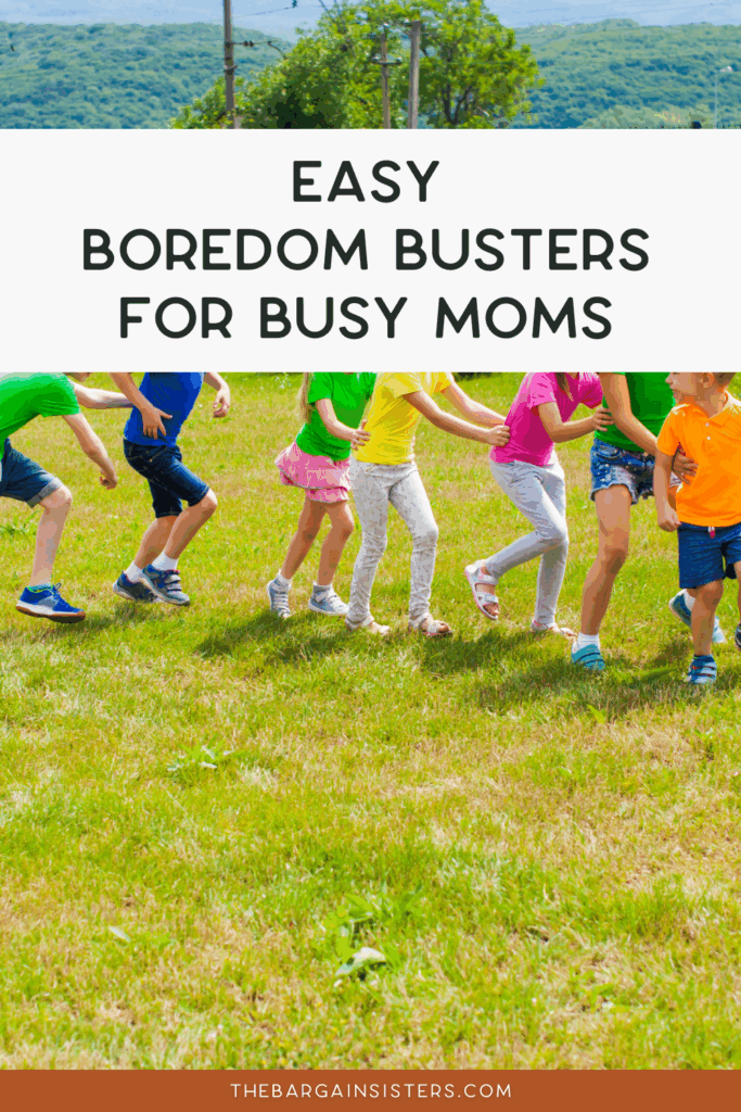 A group of children holding hands and playing outside on grass, surrounded by cheerful outdoor planters, under a banner that reads, "Easy Boredom Busters for Busy Moms.