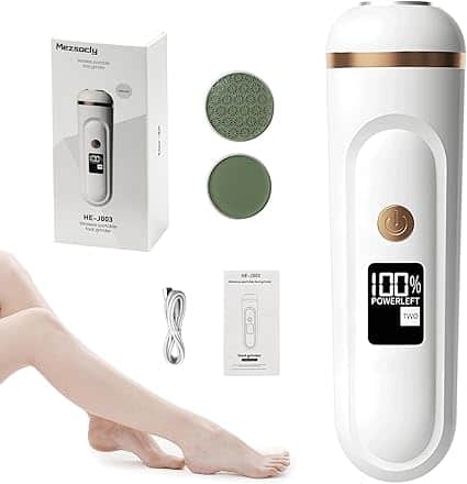 An electric foot grinder set with a digital display, power button, two round grinding heads, charging cable, user manual, product box, and a person's smooth legs in the foreground—perfect for pampering yourself with Tuesday Deals.