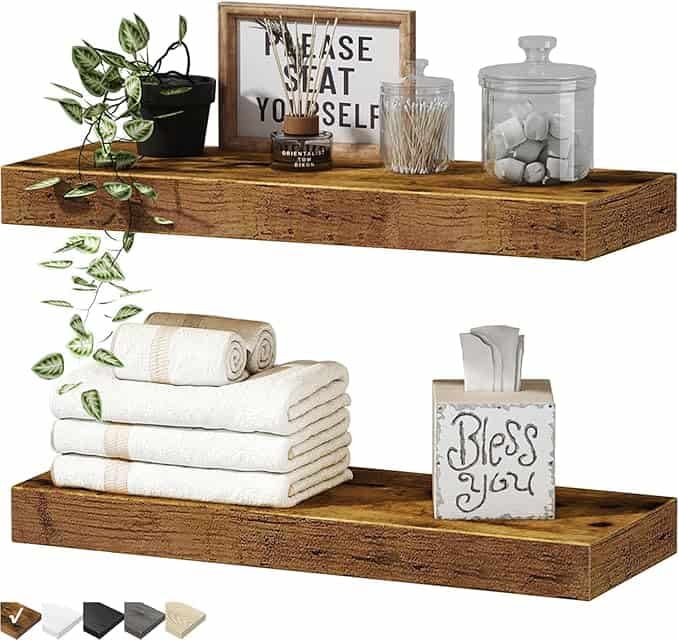 Two wooden floating shelves decorated with a potted trailing plant, a framed sign, glass jars, rolled towels, and a tissue box with “Bless you.” Four shelf color options are shown—perfect for refreshing your space with exclusive Monday Deals.