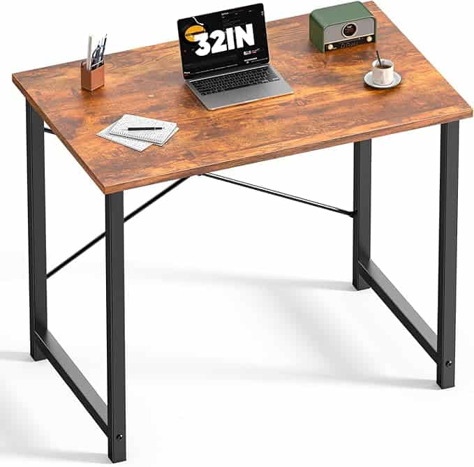 A modern wooden desk with black metal legs holds a laptop, a green radio, a cup and saucer, a pen holder with pens, and some paper—perfect for grabbing Monday Deals in style against a crisp white background.