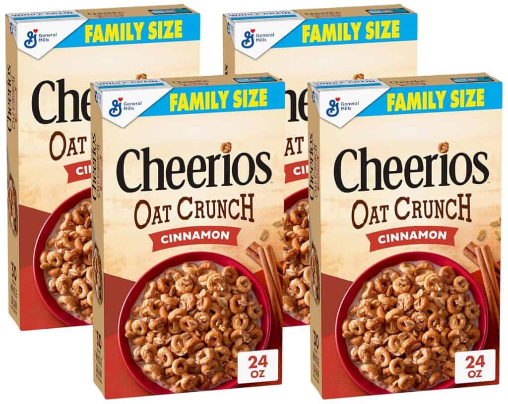 Four family-size boxes of Cheerios Oat Crunch Cinnamon cereal, each featuring a bowl of cereal and cinnamon sticks on the front. The 24 oz boxes display the General Mills logo—perfect for stocking up with Thursday Deals.
