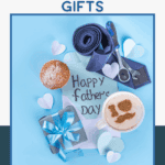 A flat lay of Father’s Day gifts on a blue background, including a blue tie, watch, gift box with blue ribbon, coffee with heart-shaped foam, a pastry, paper hearts, and a card reading “Happy Father’s Day.”.