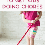 Young boy vacuuming living room carpet to show how to get kids to do their chores.