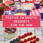 A picnic table with red, white, and blue decor displays desserts, including a rectangular cake decorated as a U.S. flag with berries, and a glass dish with a berry-topped dessert. Text overlay reads “Festive Patriotic Desserts For The Win.”.