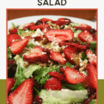 A fresh summer salad topped with sliced strawberries, crumbled cheese, walnuts, and leafy greens, displayed on a white plate. Text above reads "Crowd-Favorite Summer Strawberry Salad.