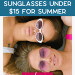 Two women lying on a blanket, each wearing stylish sunglasses—one with white frames and one with pink-tinted lenses. Text overlay reads, "Stylish Sunglasses Under $15 for Summer.