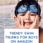 A young boy wearing blue swim goggles relaxes at the edge of a swimming pool. Text overlay reads: "Trendy swim trunks for boys on Amazon. thebargainsisters.com.