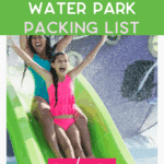 Two smiling girls in swimsuits slide down a green water slide with splashes in the background. Overlaid text reads: "Kid-Approved Water Park Packing List. Read more. thebargainsisters.com".