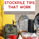 A collection of emergency food and supplies, including water, canned goods, a first aid kit, a red mug, thermos, yellow jacket, and plastic bags with dried fruit. Text reads "Budget Food Stockpile Tips That Work.