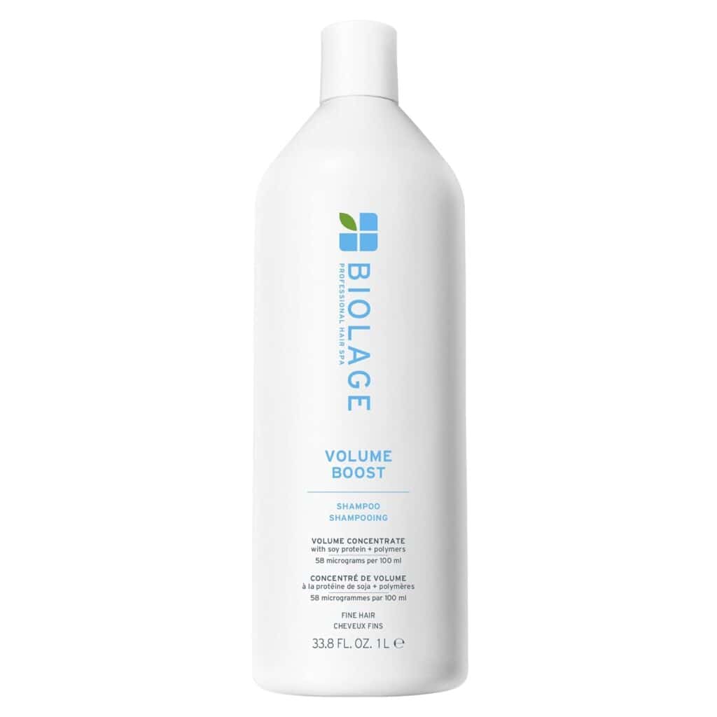 A white 33.8 fl oz bottle of Biolage Volume Boost Shampoo with blue and green text and logo, designed for fine hair to add volume. The minimalistic bottle with flat cap is perfect for your Monday Deals and haircare refresh.