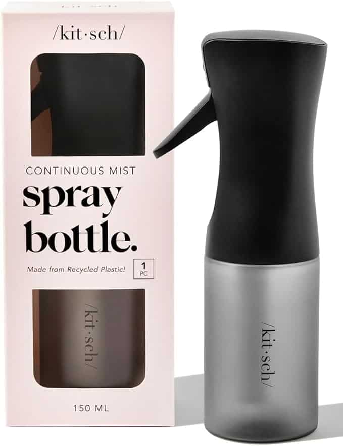 A Kitsch continuous mist spray bottle (150 ml) with a black nozzle and frosted base, shown next to its pink and black packaging. The box highlights it's made from recycled plastic—perfect for refreshing routines or grabbing in Wednesday Deals.