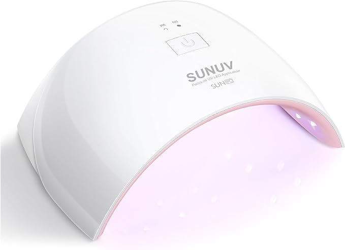 A white SUNUV LED nail lamp with a curved design emits a soft purple light underneath, used for curing gel nail polish. The power button and brand name are visible on top—perfect for snagging during Tuesday Deals.