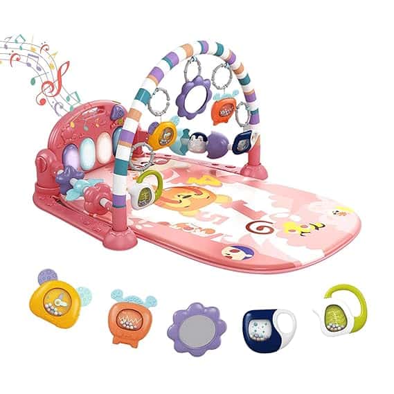 Colorful baby play gym with hanging toys, a piano keyboard, and a soft pink mat featuring cute animal designs. Don’t miss out on Friday Deals for extra savings! Additional detachable toys are displayed below the play gym. Musical notes surround the piano.