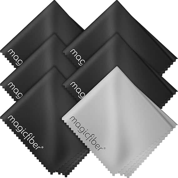 Six microfiber cleaning cloths, five black and one gray, with "magicfiber" in white on each cloth, displayed in a neat arrangement—perfect for snagging during Friday Deals.
