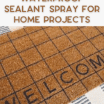 A brown doormat with a black grid pattern and the word "WELCOME" sits on a blue and white checkered rug, with text above reading "Waterproof Sealant Spray For Home Projects.