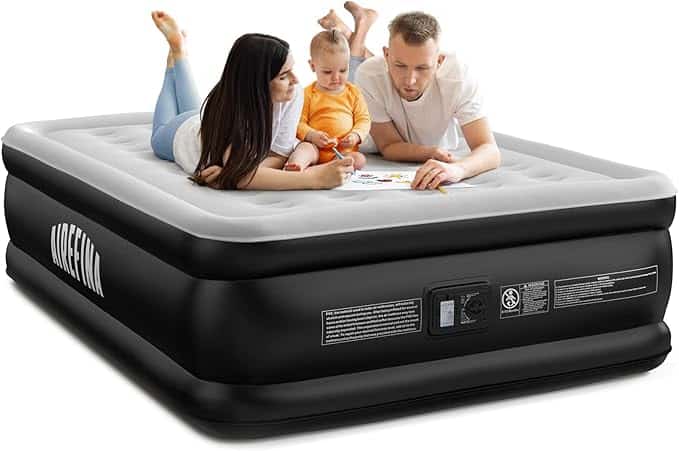 A woman, man, and child lie together on a raised black-and-gray air mattress, looking at papers and smiling. Take advantage of Thursday Deals on this mattress, which features an electric pump and product labels on the side.