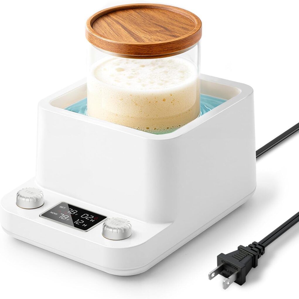 A white electric appliance with a display, two dials, and a glass container of frothy liquid topped with a wooden lid sits on top. A black power cord is plugged into the side and extends out—perfect for those Monday Deals finds.