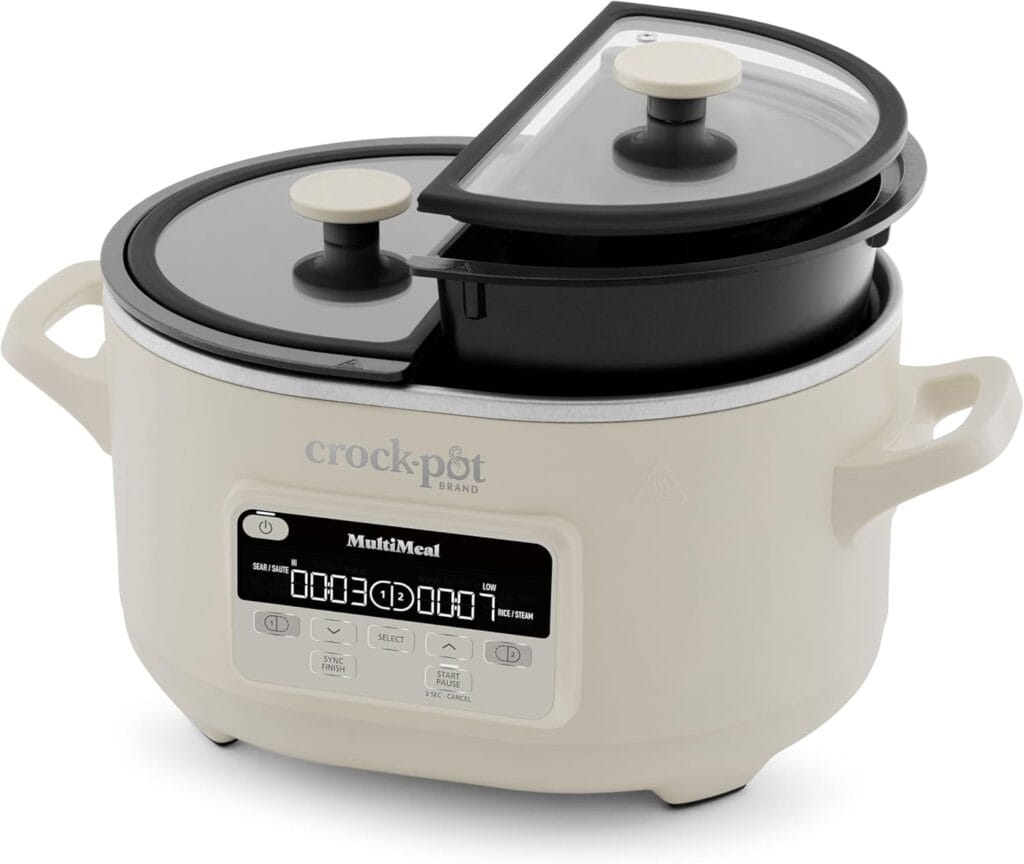 A white Crock-Pot MultiMeal slow cooker with a digital display, perfect for Wednesday Deals, featuring two black semi-circular inner pots—each with a glass lid and knob—partially overlapping inside the outer unit.