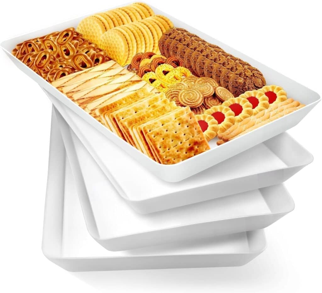 A white tray filled with an assortment of snacks including crackers, cookies, pretzels, and wafers, stacked on top of three empty white trays—perfect for sharing during Wednesday Deals.