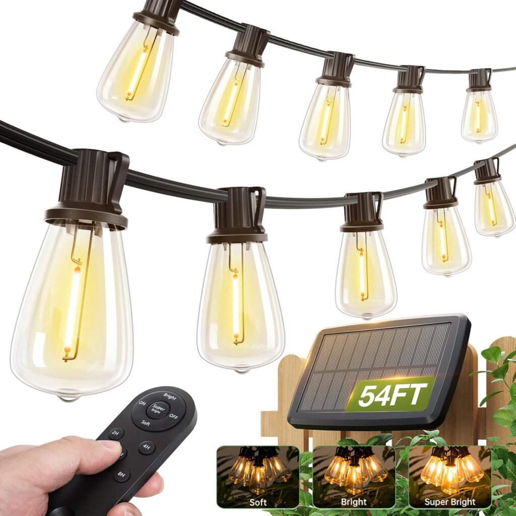 String lights with vintage-style bulbs hang outdoors. A hand holds a remote control, while a solar panel labeled "54FT" rests on a wooden fence. Shop Wednesday Deals and enjoy three light modes: soft, bright, and super bright.