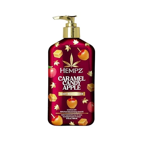 A red bottle of Hempz Caramel Candy Apple Body Moisturizer with a gold pump, decorated with apples, caramel cubes, and leaves. The label highlights natural hemp seed oil—perfect for stacking up on Tuesday Deals!.
