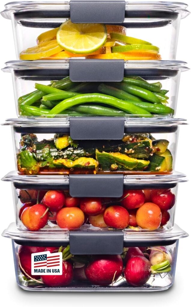 A stack of five clear food storage containers—perfect for Wednesday Deals—overflow with lemon slices, green beans, sautéed vegetables, cherries, and radishes. A "Made in USA" label is visible on the bottom container.