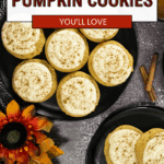 Top view of frosted caramel pumpkin cookies on black plates, surrounded by a sunflower, cinnamon sticks, and a bowl of caramel. Text overlay reads “Caramel Pumpkin Cookies You’ll Love.”.