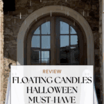 A stone house entrance decorated for Halloween with floating candles hanging above double doors and two ghost figures on either side. Text overlay reads: "Review: Floating Candles Halloween Must-Have.