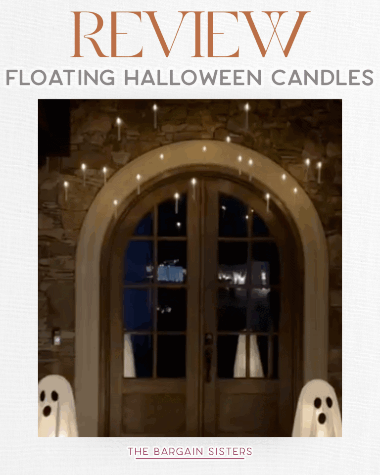 A stone entryway with double wooden doors, adorned with floating Halloween candles above and two ghost decorations flanking the doors. An air conditioner cover blends into the scene. Text reads: “REVIEW Floating Halloween Candles. The Bargain Sisters.”.
