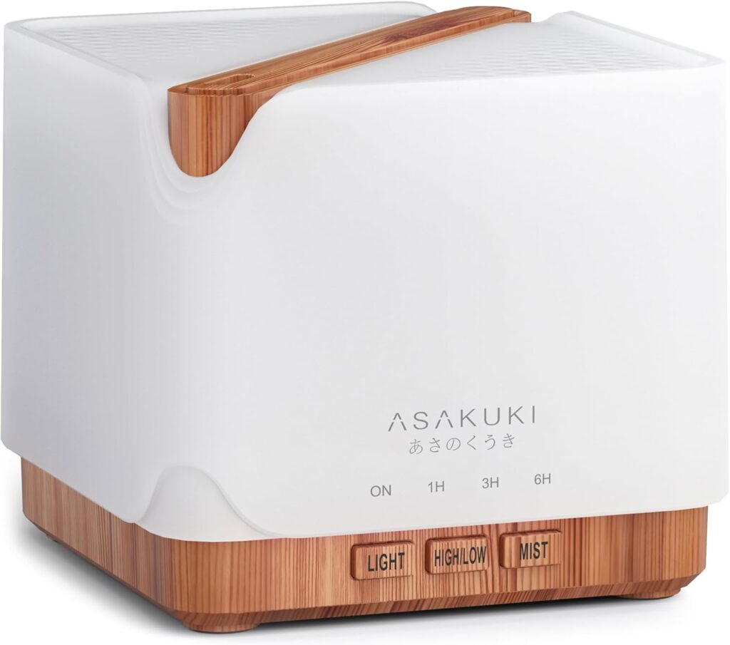 A square-shaped ASAKUKI essential oil diffuser with a white top and wood-grain base. It has control buttons labeled ON, 1H, 3H, 6H, LIGHT, HIGH/LOW, and MIST on the front.
