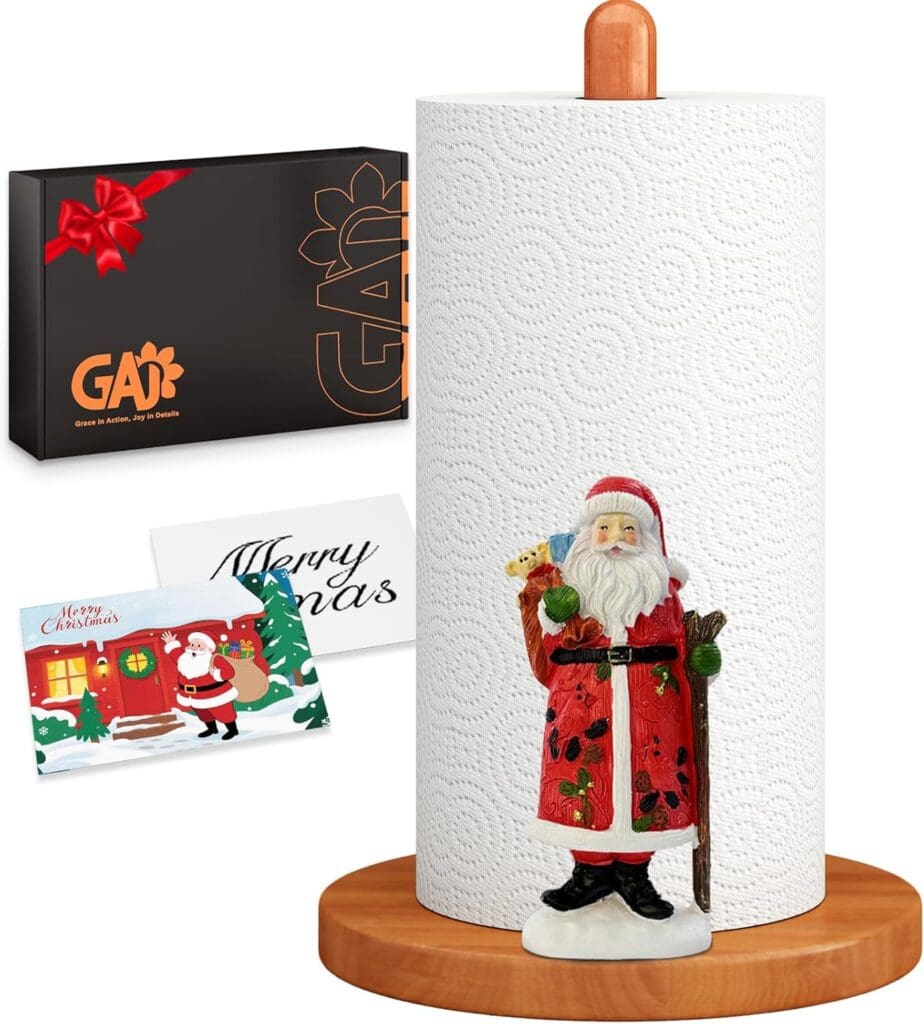 A paper towel holder with a Santa Claus figure, a wooden base and top, plus a gift box and two holiday cards—one reading "Merry Christmas"—makes for the perfect festive addition to your kitchen during Monday Deals.