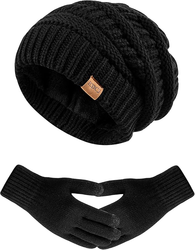 A black knitted beanie with a small brown tag is shown above a pair of black knitted gloves on a white background.