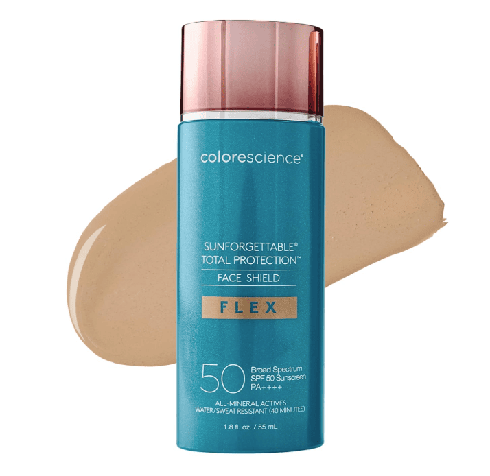 A bottle of Colorescience Total Protection Face Shield Flex SPF 50, a premium beauty essential, is displayed before a smear of beige product. The teal bottle features a metallic cap and gold label accents.