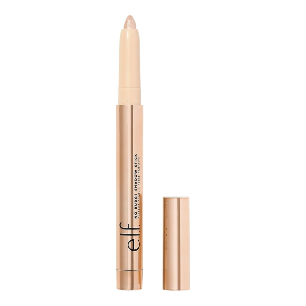 A gold-colored e.l.f. No Budge Shadow Stick stands upright with its cap off, revealing the light cream eyeshadow tip—perfect for creating long-lasting looks. Shop this bestselling eyeshadow stick now and enjoy a makeup discount.