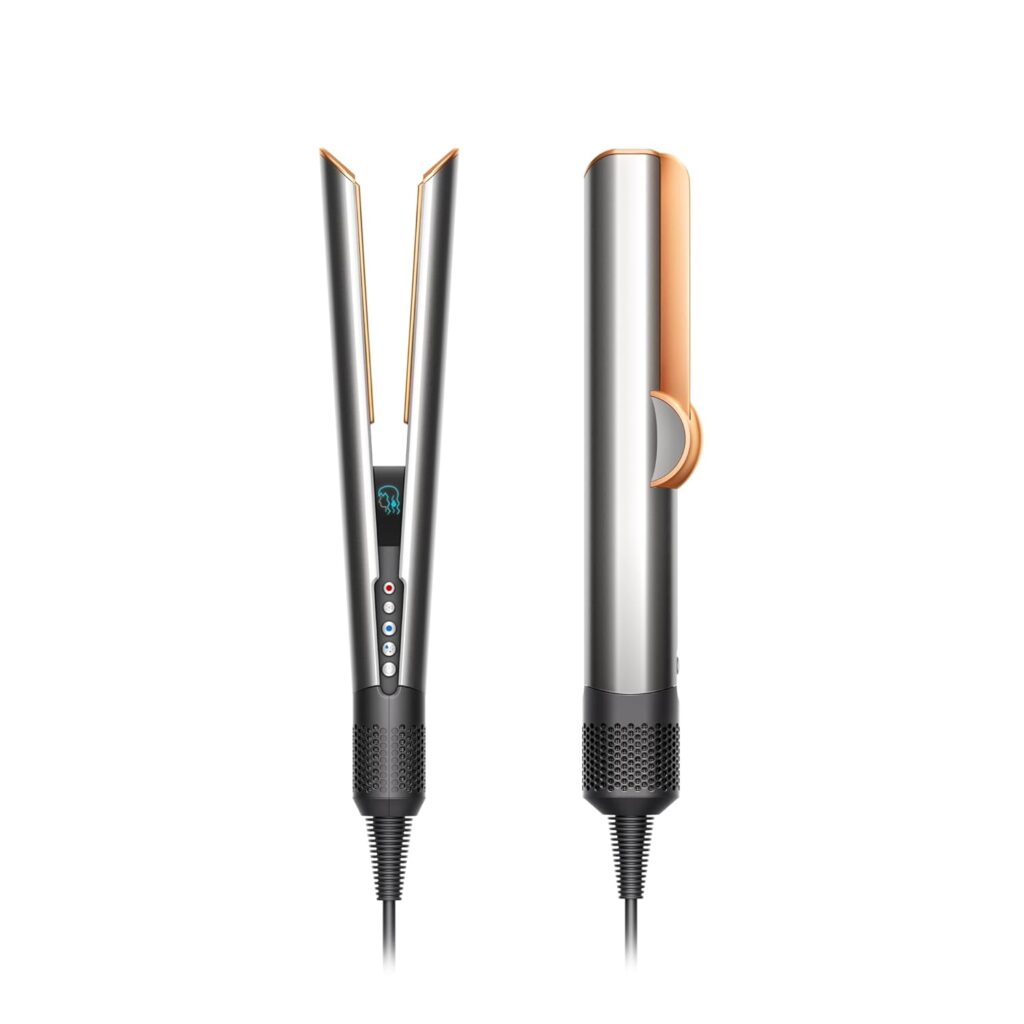 A modern silver and black hair styling tool with gold accents, shown from the front and side. It has control buttons, an LED display, and a long cord at the base.