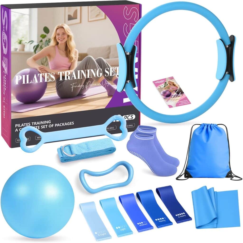 A Pilates training set including a Pilates ring, exercise ball, resistance bands, yoga socks, stretch band, handles, a blue drawstring bag, and an exercise guide. A smiling woman appears on the packaging box.