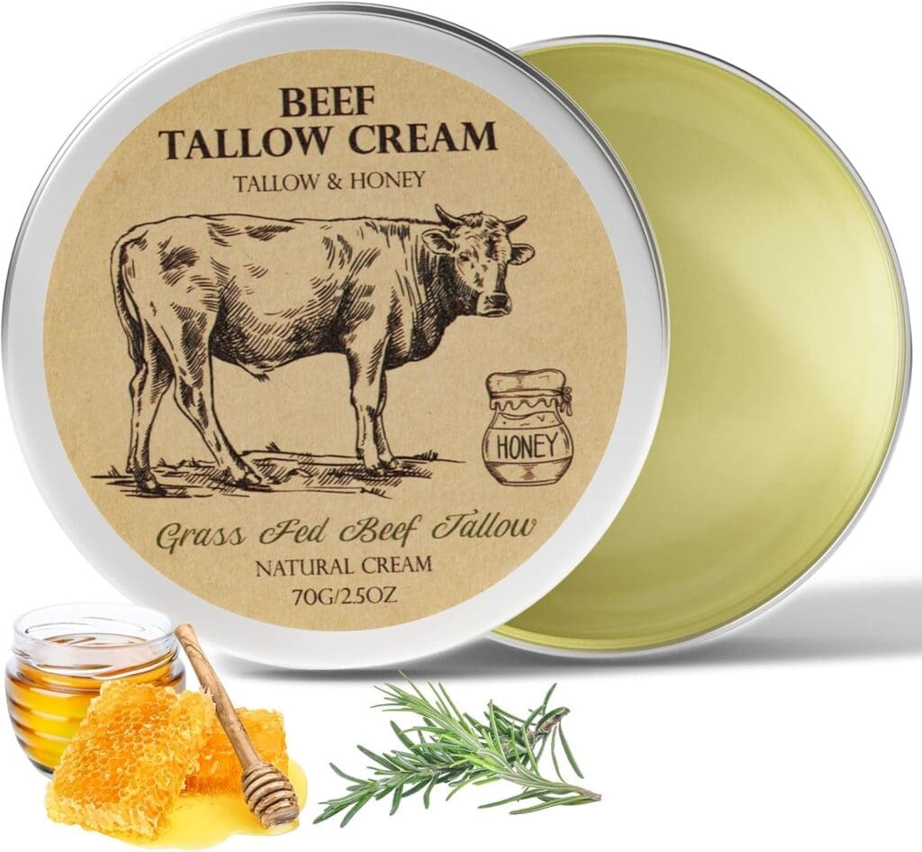 An open tin of beef tallow cream with a label showing a cow, a honey jar, and text. In front are honeycomb, a honey dipper, a small bowl of honey, and a sprig of rosemary. The cream is pale yellow.