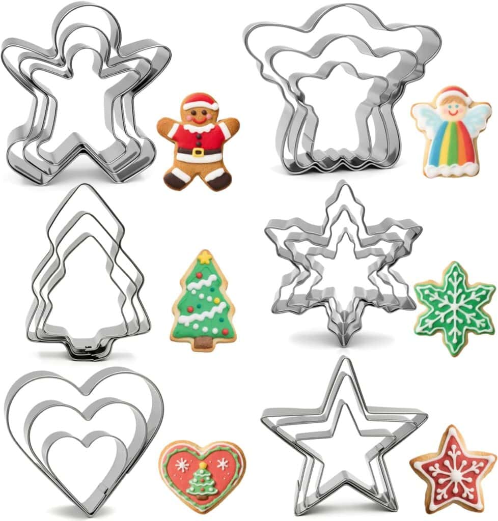 Four sets of metal cookie cutters—gingerbread person, angel, tree, snowflake, heart, and star—are shown next to matching decorated Christmas cookies.