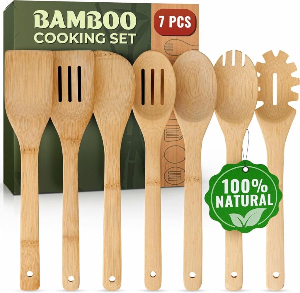 A set of seven bamboo cooking utensils is displayed in front of a green box labeled "Bamboo Cooking Set." A green tag on one utensil reads "100% Natural.