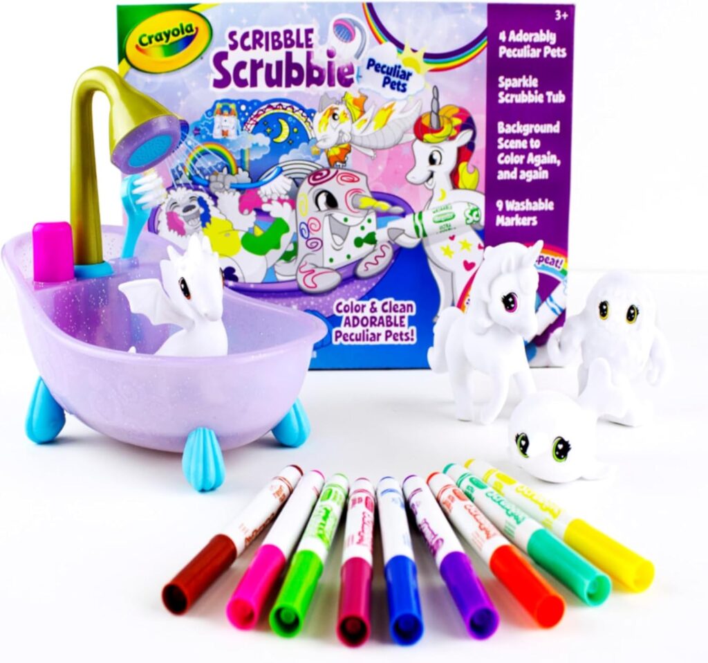 A Crayola Scribble Scrubbie Peculiar Pets set is displayed with a purple toy bathtub, four white animal figurines, colorful washable markers, and a box showing the animals being colored and cleaned.