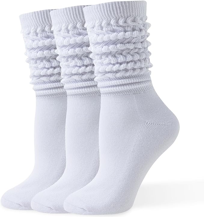 Three pairs of white crew socks are displayed standing upright in a row, featuring a textured, ribbed, and scrunched design around the cuffs.