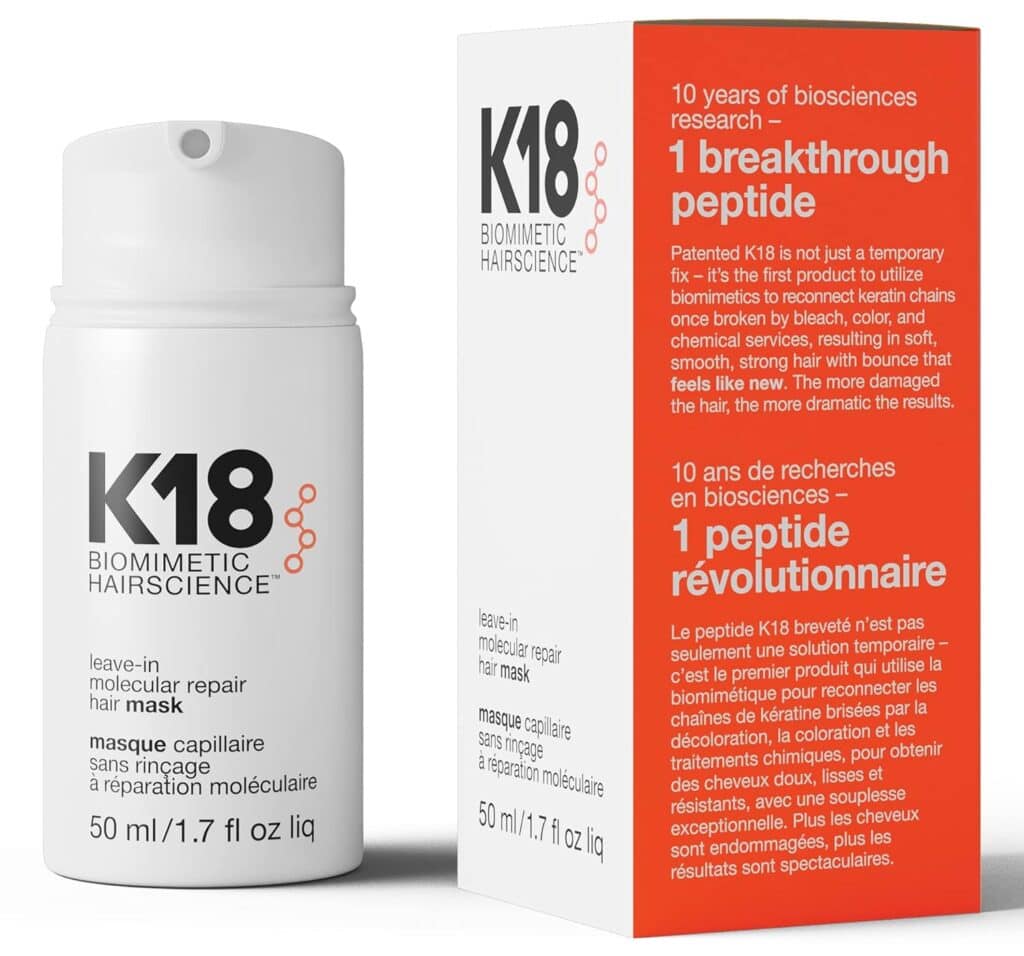 A white bottle and box of K18 Biomimetic Hairscience leave-in molecular repair hair mask, featuring premium black and red text highlighting its benefits and scientific formulation, labeled as 50 ml (1.7 fl oz).
