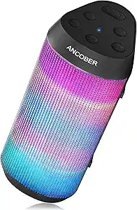 A portable ANCOBER Bluetooth speaker featuring colorful LED lights, black top with control buttons, and a glowing gradient pattern in blue, pink, and purple on its body.