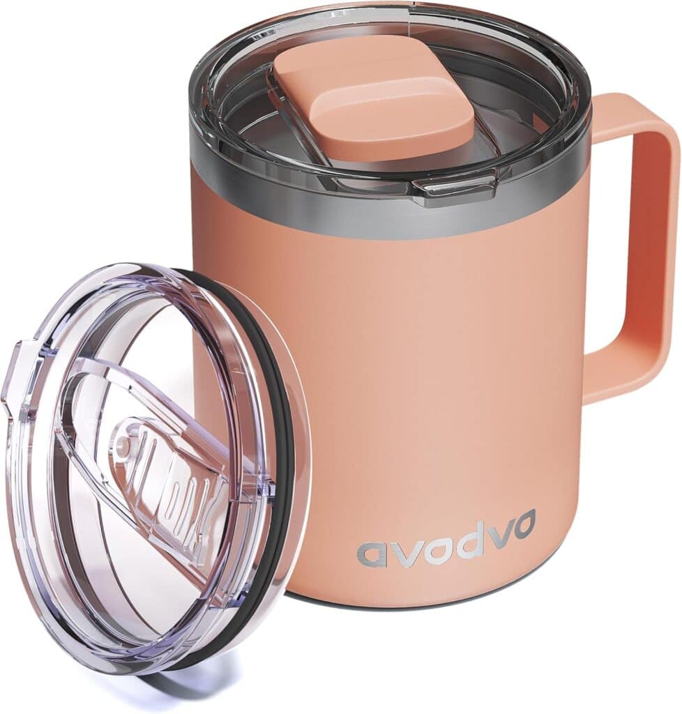 A peach-colored insulated mug with a handle and transparent lid. Another similar transparent lid is shown lying flat beside the mug. The mug has the word "avodva" printed on the front.