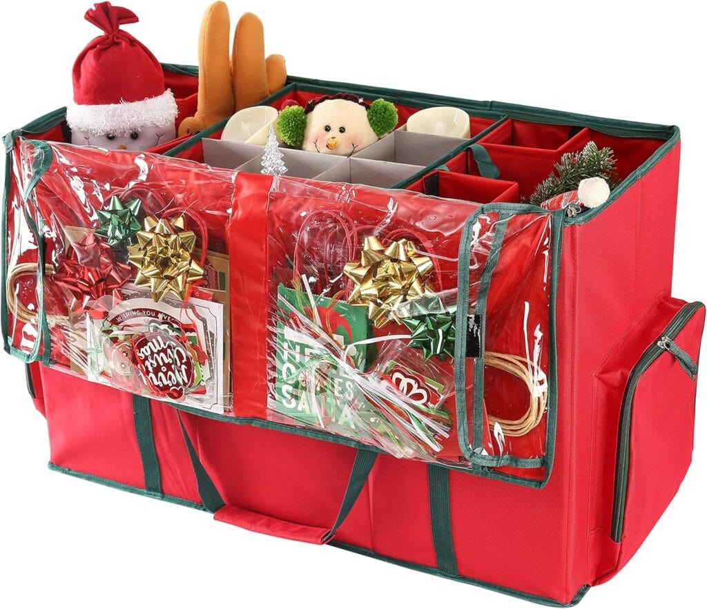 A red and green storage bag with clear plastic pockets, filled with holiday ornaments, bows, cards, and festive decorations, including a Santa plush and a snowman plush. The bag has handles and side pockets.