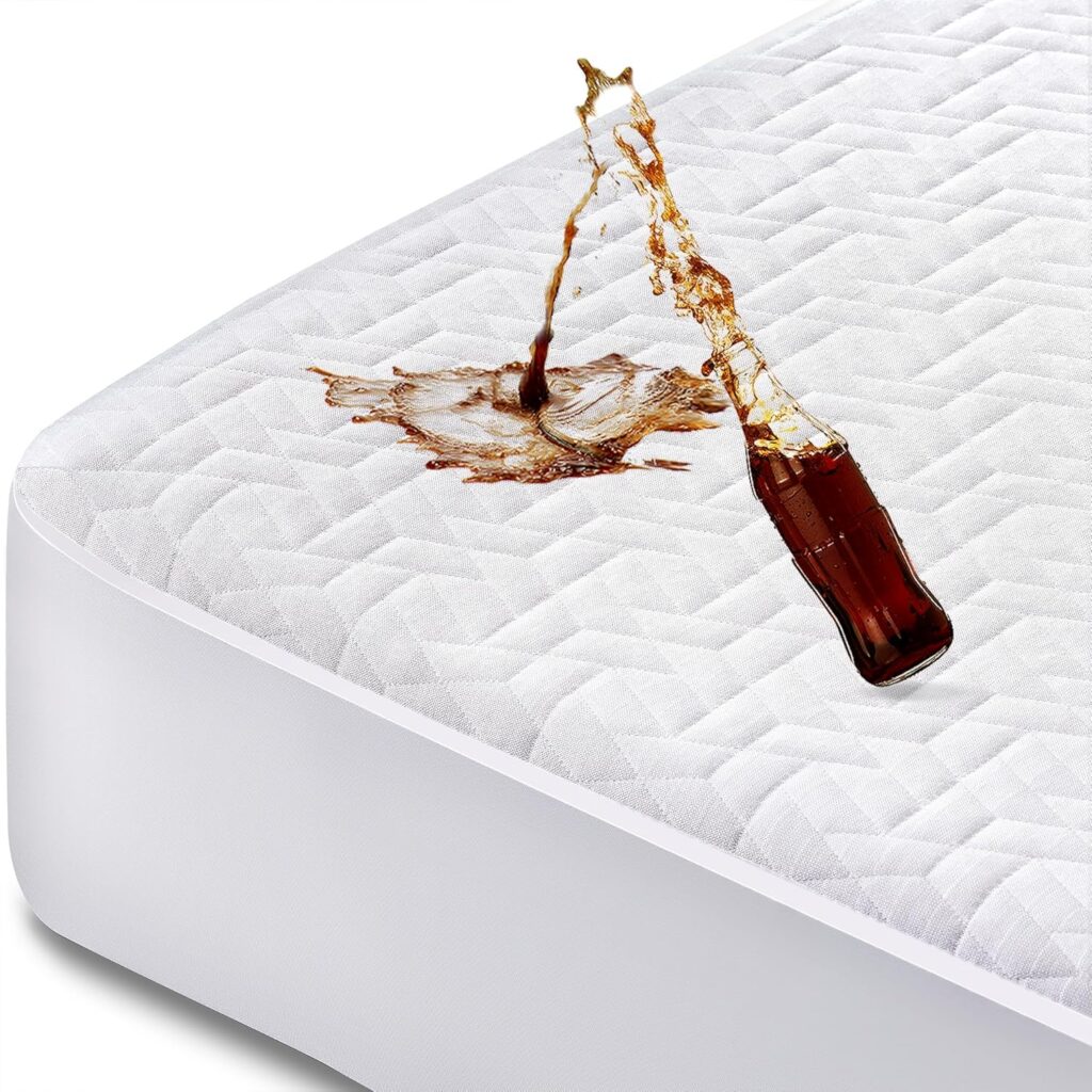 A bottle of dark soda spills onto a white, textured mattress protector, demonstrating the protector’s ability to resist liquid absorption.